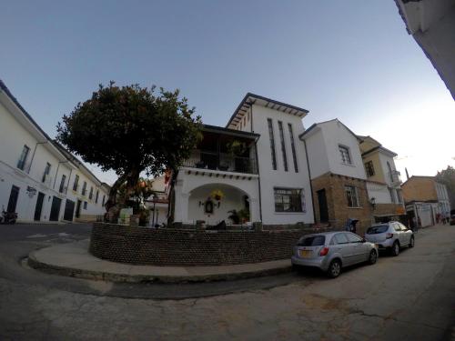a house with a car parked in front of it at Hotel La Herreria Colonial in Popayan