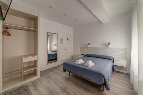 Postel nebo postele na pokoji v ubytování Hostal Lar