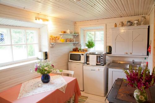 a small kitchen with a table and a counter top at Adami Country Guesthouse in Vainupea