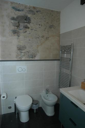 a bathroom with a toilet and a sink at Castello D'Alcontres Guest House 3 stelle in Nizza di Sicilia