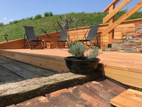 a deck with two chairs and a pot with plants at Tourist farm Artisek in Štore