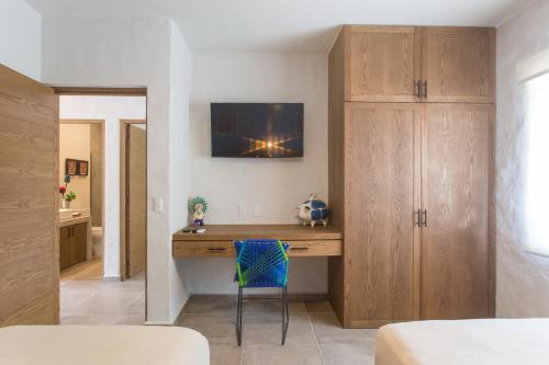 a room with a wooden desk in a bedroom at Casa Malva in Sayulita