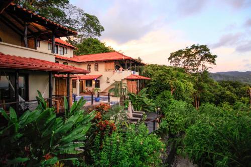 a house on a hill with trees and plants at Casa Marbella in Santa Teresa Beach