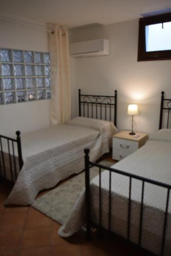 En eller flere senge i et værelse på Villa Serena Alghero