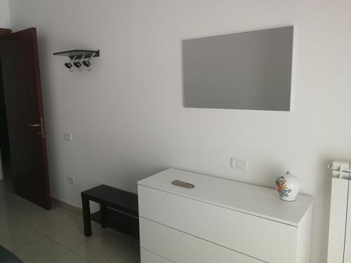 a room with a white wall and a white dresser at Confortable Apartment in Vasto in Vasto