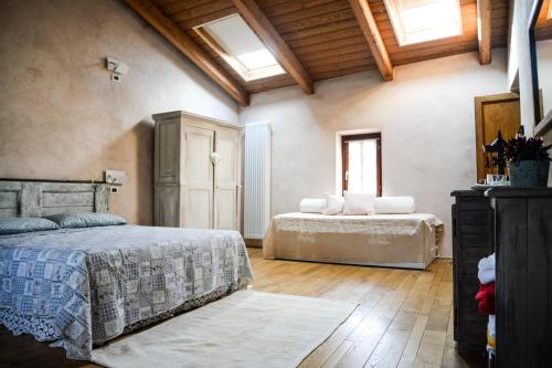 two beds in a large room with wooden ceilings at Agriturismo Magnarosa in Barge