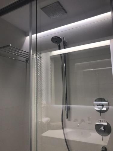 a shower with a glass door with a tub at Exclusive Malaga Skyline in Málaga