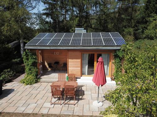 a small cabin with solar panels on the roof at Ferienhaus Ilfeld in Ilfeld