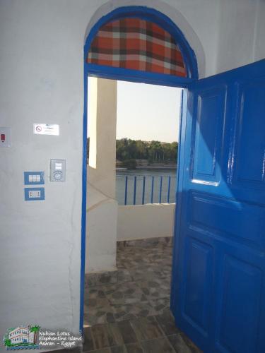 a blue door with a view of the water at Nubian Lotus in Aswan
