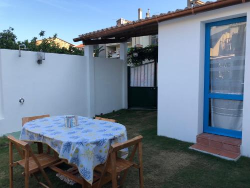 a table with a blue and white table cloth on it at Dépendance in San Vito