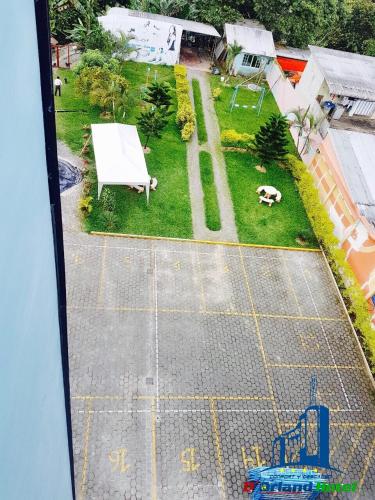 an aerial view of a yard with a white bench at D'ORLAND HOTEL in Santo Domingo de los Colorados