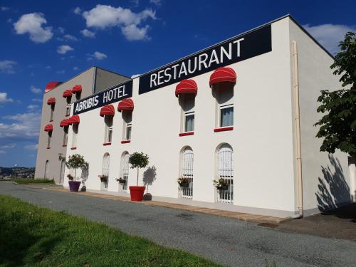 a white building with a restaurant sign on it at L'Abribis in Firminy