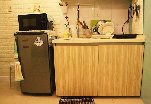 a small kitchen with a counter and a refrigerator at French Nest at Baguio- Megatower Residences in Baguio