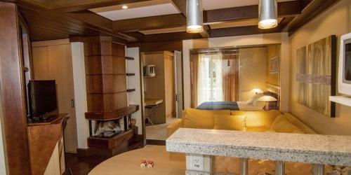 
a living room filled with furniture and a tv at FLAT PRESTIGE SERRA RS 5* in Canela
