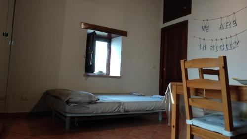 a small bed in a room with a window at Open Space Marianna in Trabia