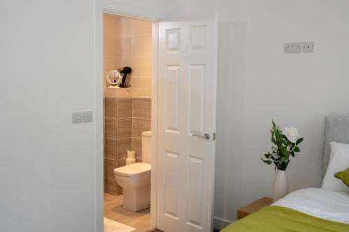 a bathroom with a bed and a toilet and a shower at Fantastic Large House with Private Parking in Bradford
