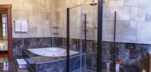a bathroom with a shower and a bath tub at Verula City Luxury Villa in Trabzon