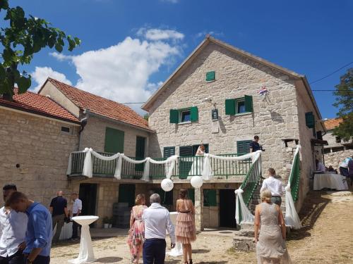 a group of people standing outside of a building at Apartman Studio Zdravko Eco Village in Imotski