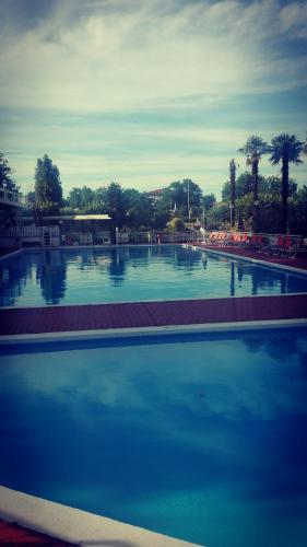 a large swimming pool with blue water at Villaggio Costa d'Argento in San Vito Chietino