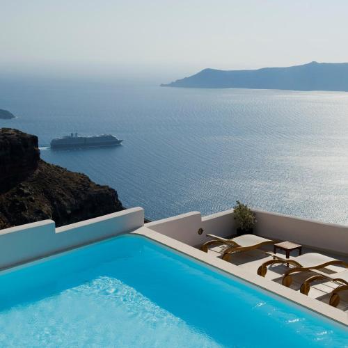 a swimming pool with a view of the ocean at Gold Suites - Small Luxury Hotels of the World in Imerovigli