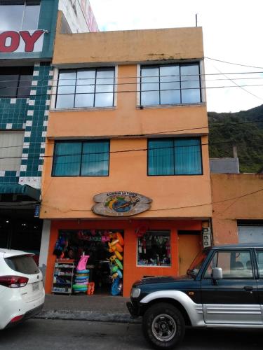 a truck parked in front of a building at Jorge's apartment in Baños