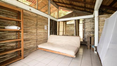 a room with a bed in the middle of a room at La pajarera in Mazunte