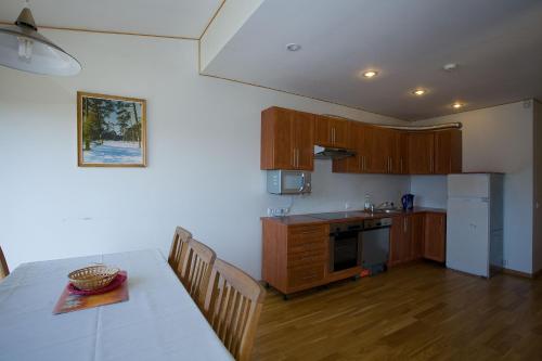 a kitchen with a table and a dining room at Love Island Guesthouse in Druskininkai