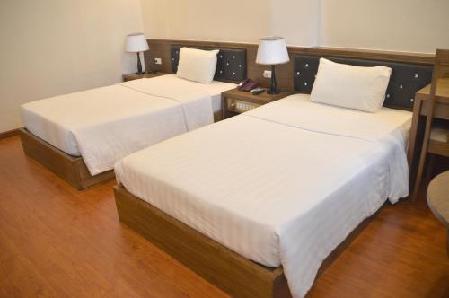 Postel nebo postele na pokoji v ubytování Phu Tho Hotel
