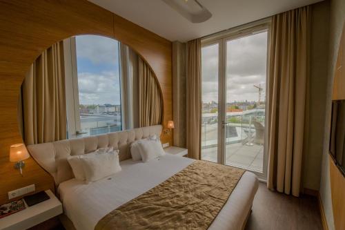 a hotel room with a bed and a large window at Grand Hotel Downtown in Amsterdam