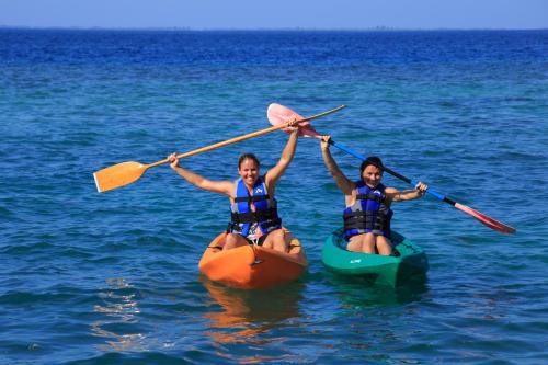 two people in kayaks in the water at Equator Village Maldives in Gan