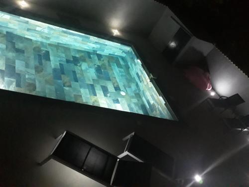 an overhead view of a swimming pool at night at Appartement Pérols Centre in Pérols