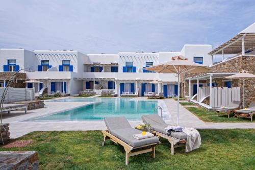 a swimming pool with two lounge chairs and an umbrella at Villa Del Sol Mykonos in Ornos