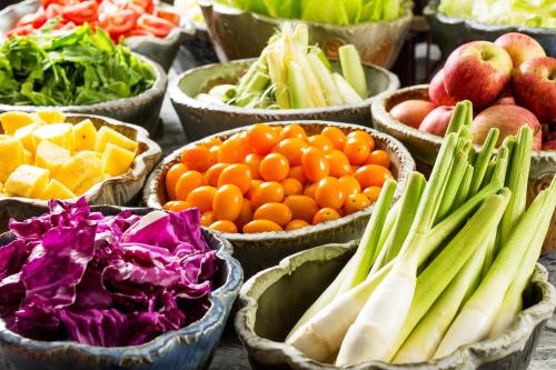 a display of fruits and vegetables in bowls on a table at 礁溪晶泉丰旅 Wellspring by Silks Jiaoxi in Jiaoxi