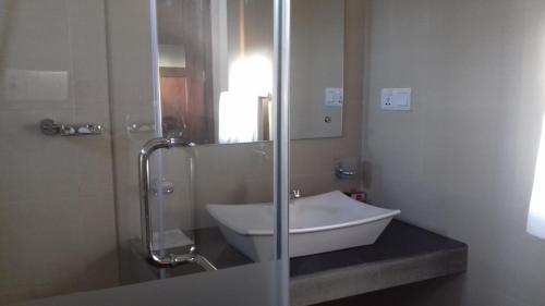 a bathroom with a sink and a glass shower at Villa A50 in Negombo
