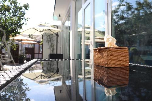 a wicker basket is hanging on the side of a house at The Great Wall Box House - Beijing in Miyun
