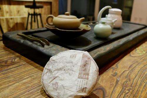 a table with a tea pot and other items on it at The Great Wall Box House - Beijing in Miyun