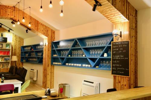 a bar with blue shelves in a restaurant at The Great Wall Box House - Beijing in Miyun
