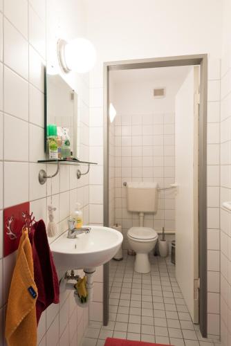 a bathroom with a sink and a toilet at Apartment in der Yogaschule in Cologne
