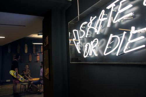 a neon sign on the wall of a restaurant at Sant Jordi Hostels Sagrada Familia in Barcelona