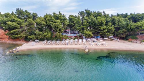 an aerial view of a beach with chairs and tables at Porfi Beach Hotel in Nikiti
