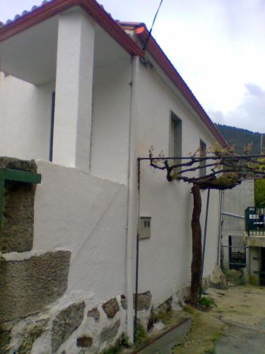 a white building with a sign on the side of it at Casa de la Abuela in Bubaces