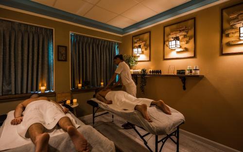 two men laying on beds in a room at Casa Boutique Hotel in Nahariyya