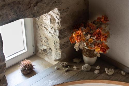 a vase of flowers sitting on a floor next to a window at Villa Cindro House in Podstrana