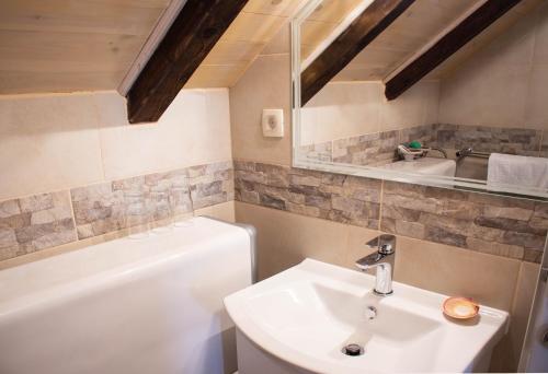 a bathroom with a sink and a bath tub at Villa Cindro House in Podstrana