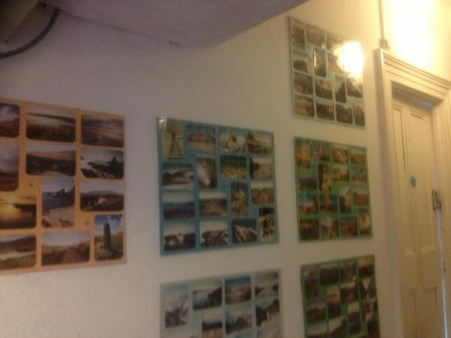 a wall with pictures and photos on it at Causeway Coast Independent Hostel in Portstewart