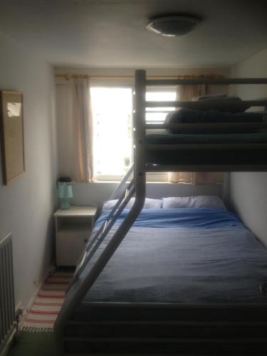 a bedroom with a bunk bed and a window at Causeway Coast Independent Hostel in Portstewart
