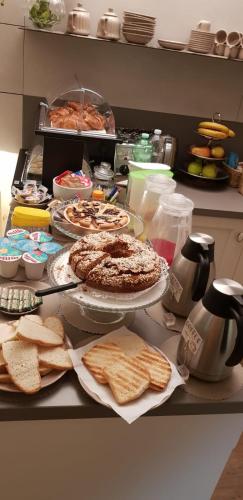 a table with food and bread on a counter at Accademia 21 in Mantova