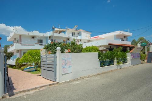 a white building on the side of a street at Sea Harmony in Kalathos