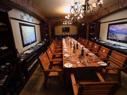 a large dining room with a long long table at Kloofzicht Lodge & Spa in Muldersdrift