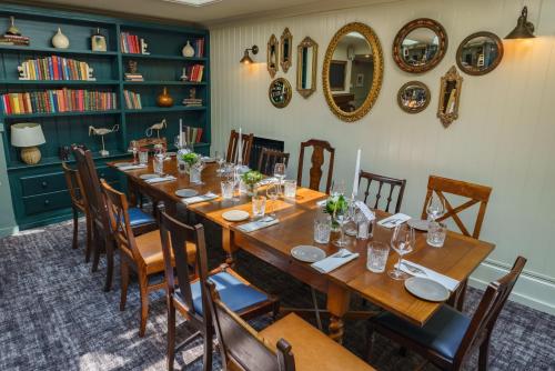 a dining room with a long table and chairs at Swan Hotel in Arundel